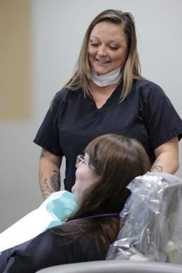 Dental assistant helping emergency patient feel co